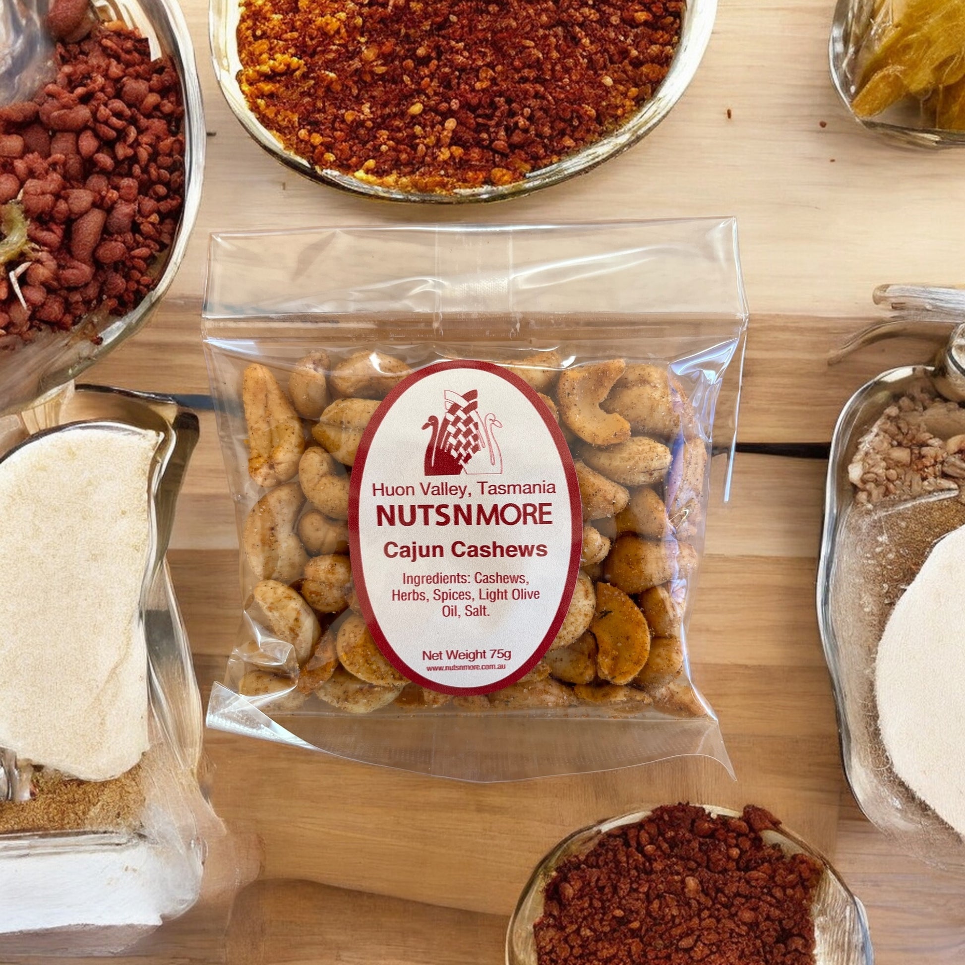Premium Tasmanian Cajun Cashews in clear packaging showing spiced coating texture.