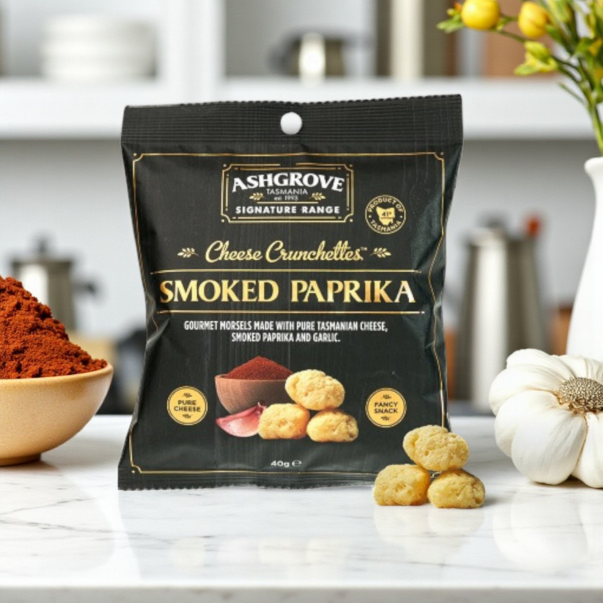Packaging of Ashgrove Cheese Tasmania Crunchettes Smoked Paprika on a kitchen counter.