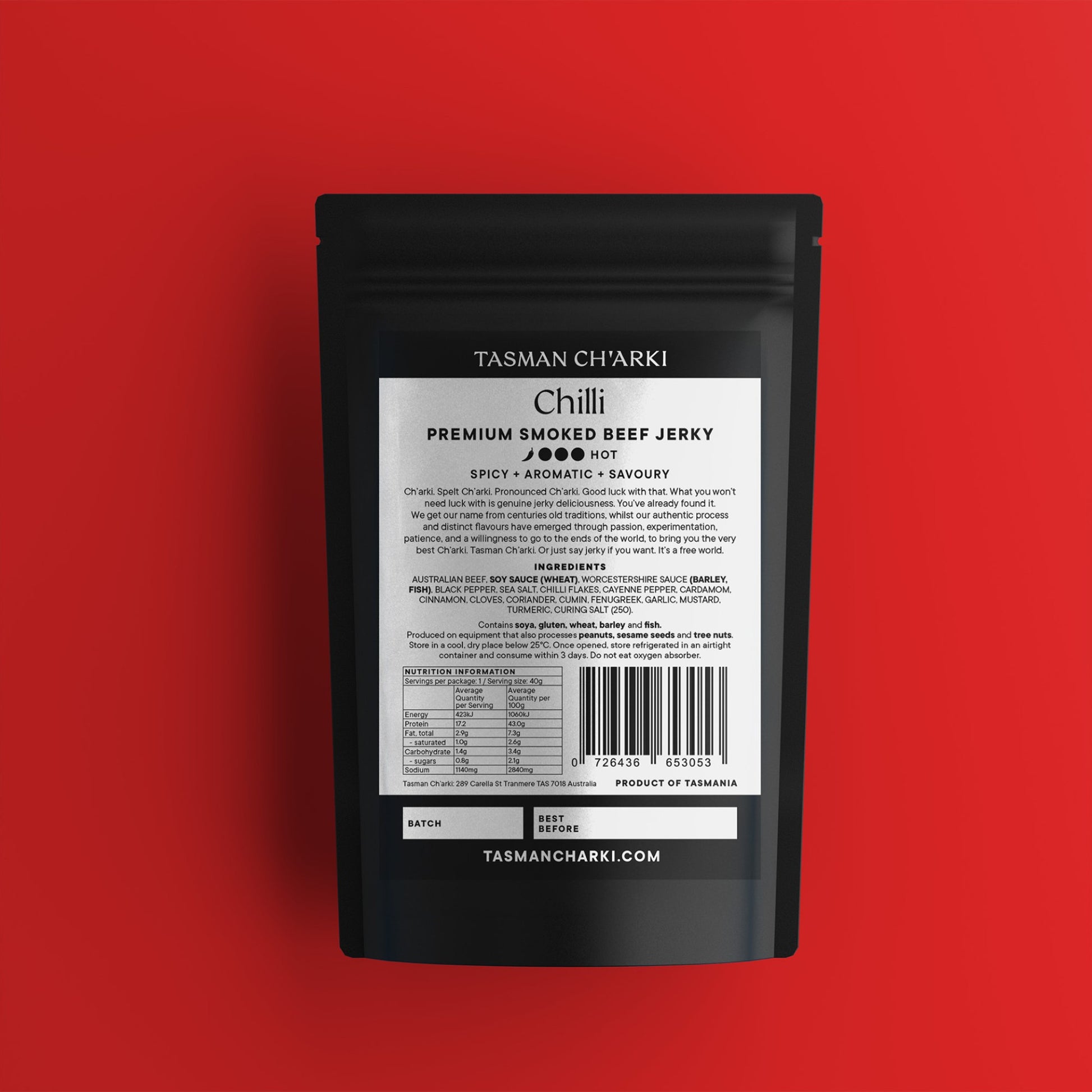 Black package of Tasman Ch'arki Tasmanian Premium Smoked Beef Chilli Jerky on a red background