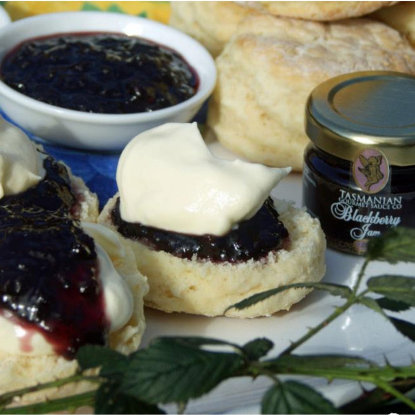 Tasmanian Blackberry jam spread on fresh scones with cream showing serving suggestion and rich texture
