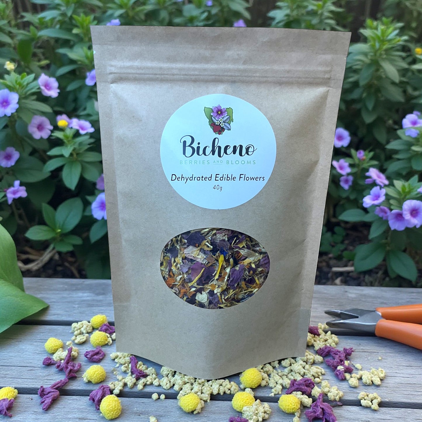 Bicheno Tasmania dehydrated edible flowers package on a wooden surface with flowers in the background