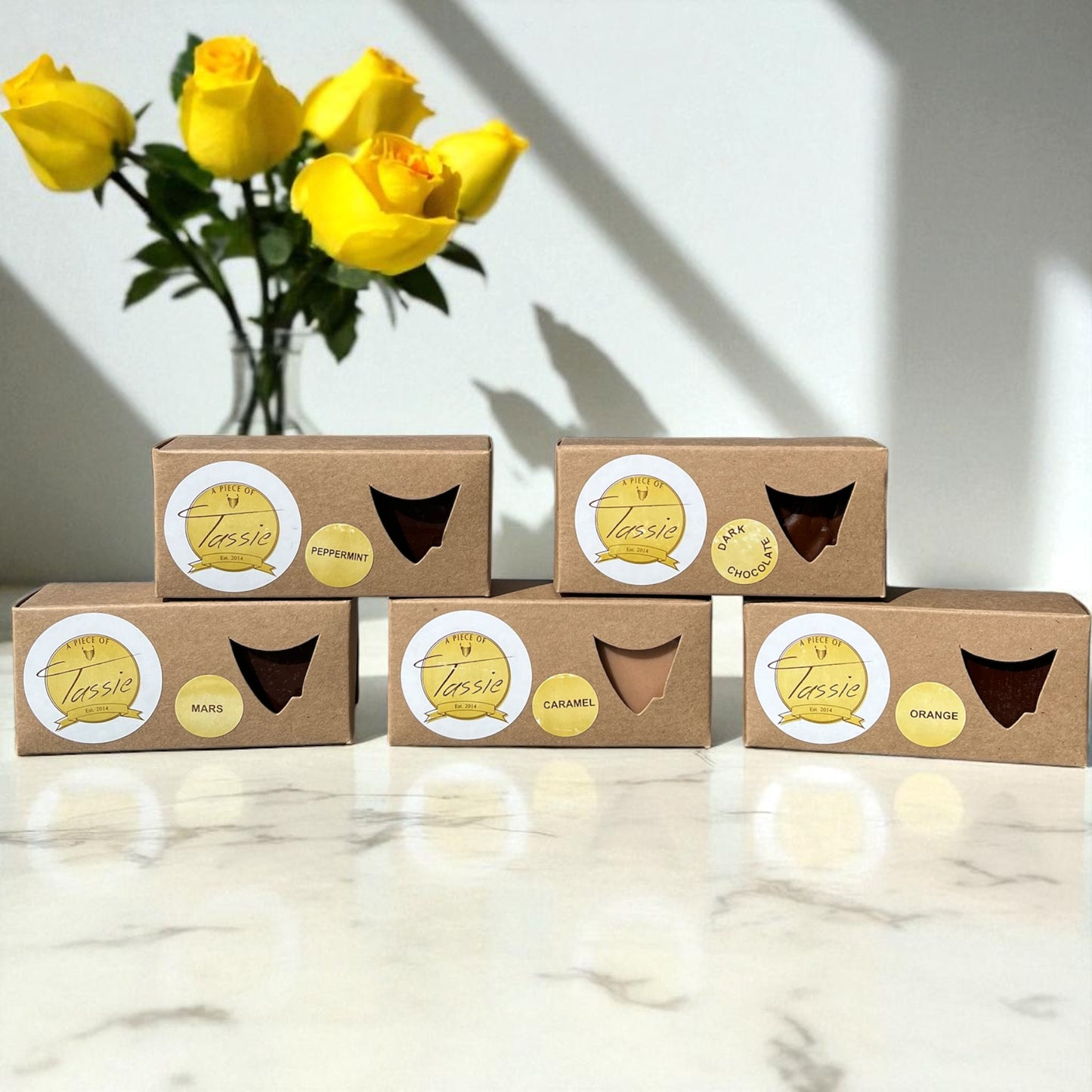 Handmade Tasmanian fudge variety pack showing five different flavours including caramel, dark chocolate, peppermint, orange and Mars caramel