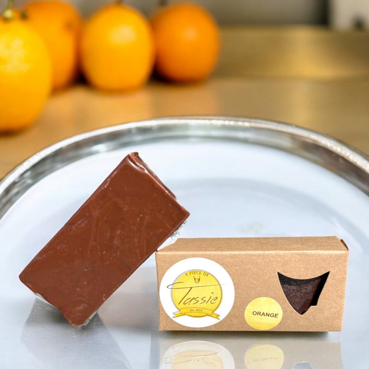 Orange and dark chocolate fudge piece elegantly arranged on a silver tray as gourmet Tasmanian gift