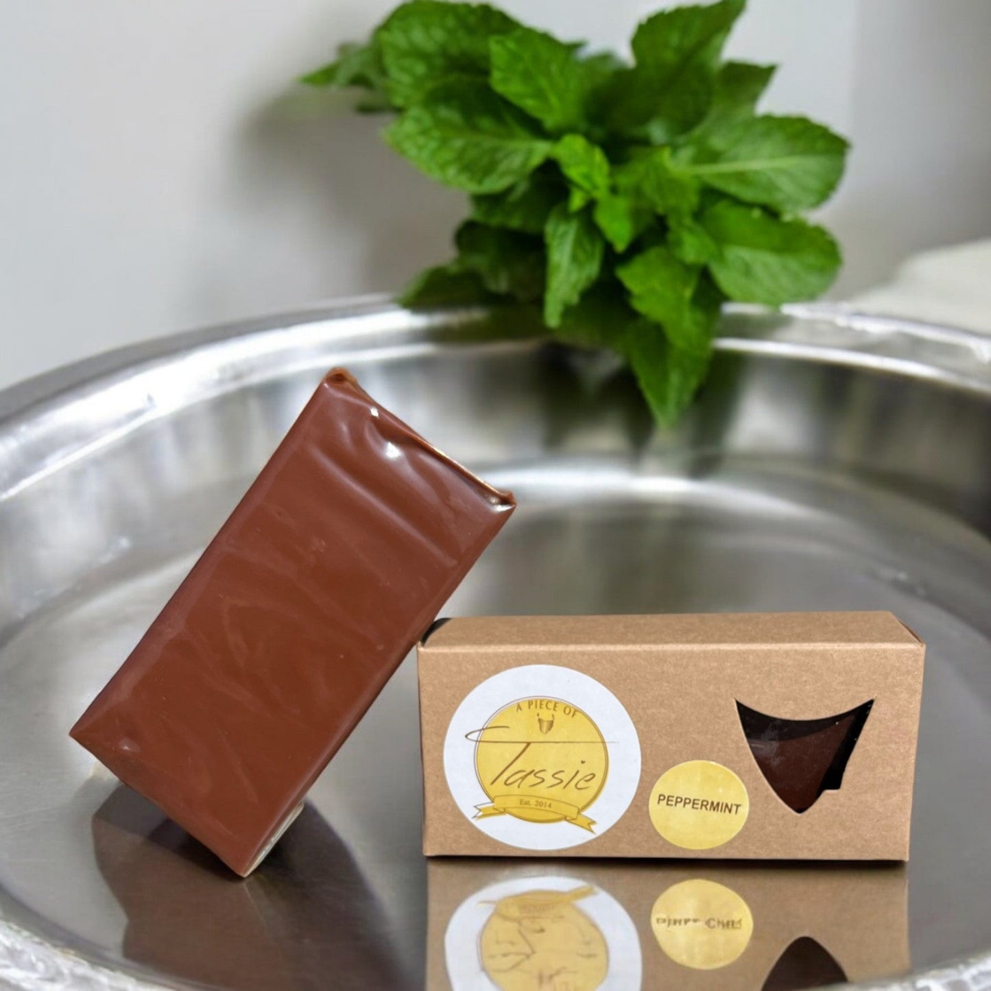 Handcrafted Tasmanian peppermint fudge with dark chocolate pieces on white background