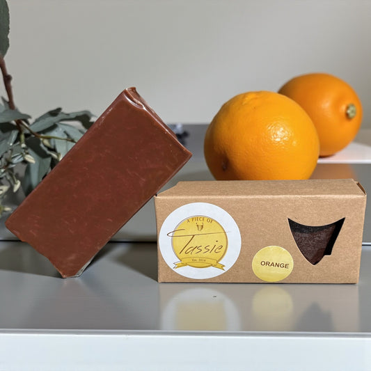 Tasmanian Chocolate Orange Fudge bar with oranges in the background.