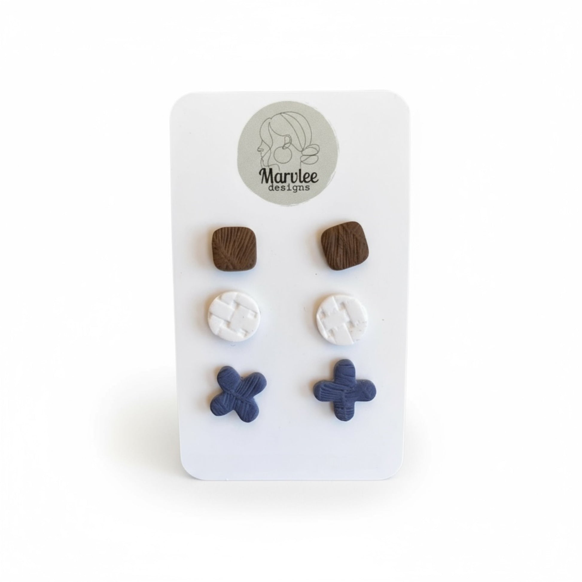 Close-up of lightweight polymer clay stud earrings showing handcrafted detail