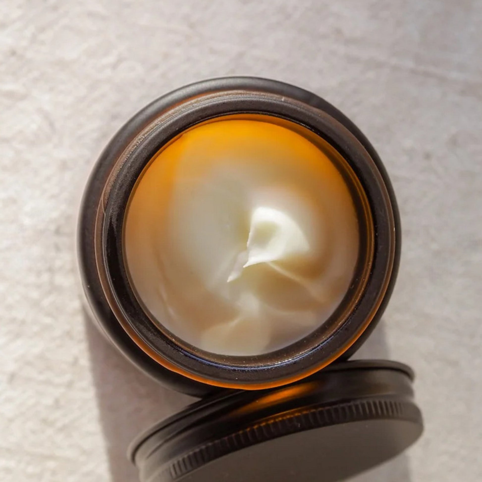 Close-up of orange sandalwood tallow cream showing smooth protective texture