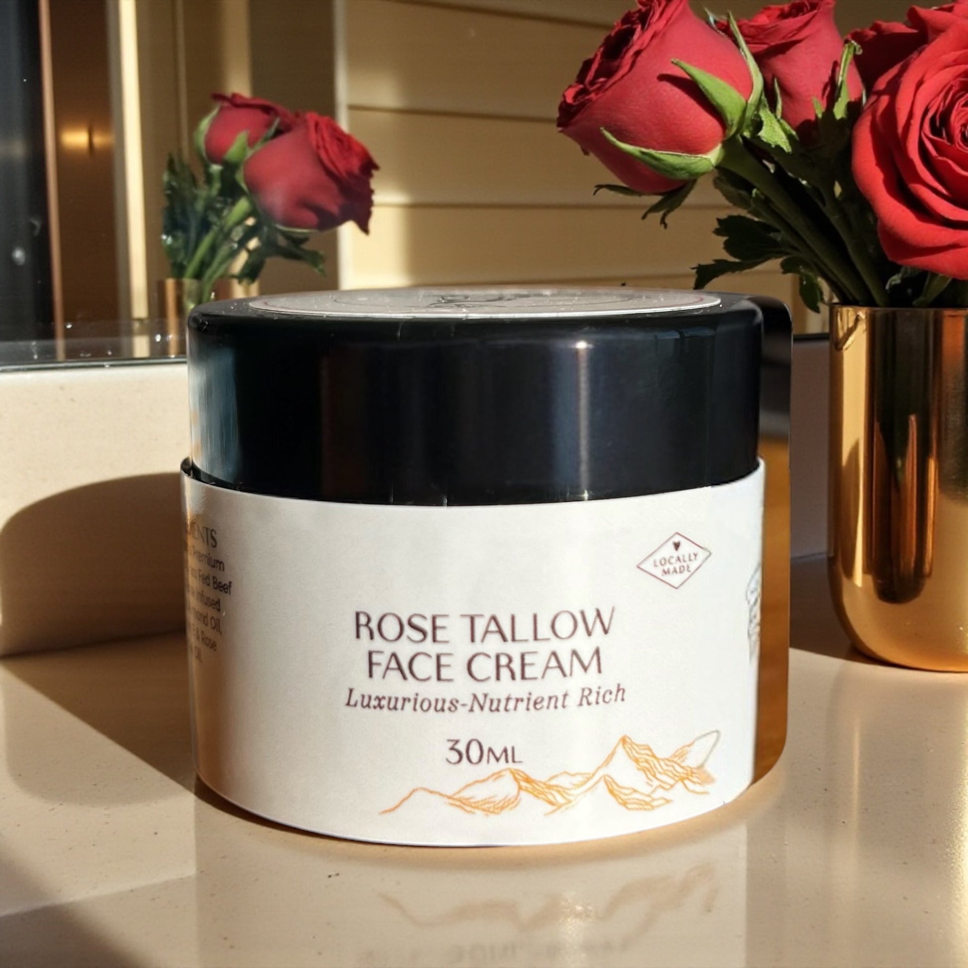 Tasmanian Valley Tallow Rose Face Cream jar surrounded by fresh roses