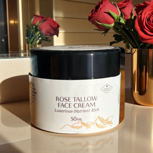 Tasmanian Valley Tallow Rose Face Cream jar surrounded by fresh roses