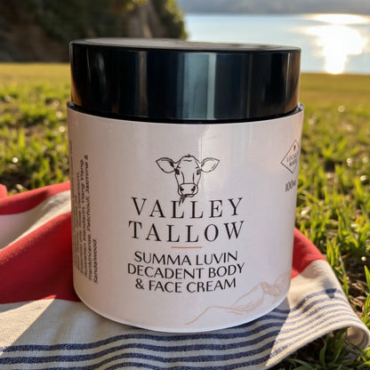 Valley Tallow Summa Luvin Decadent Body and Face Cream jar held outdoors with Tasmanian landscape background