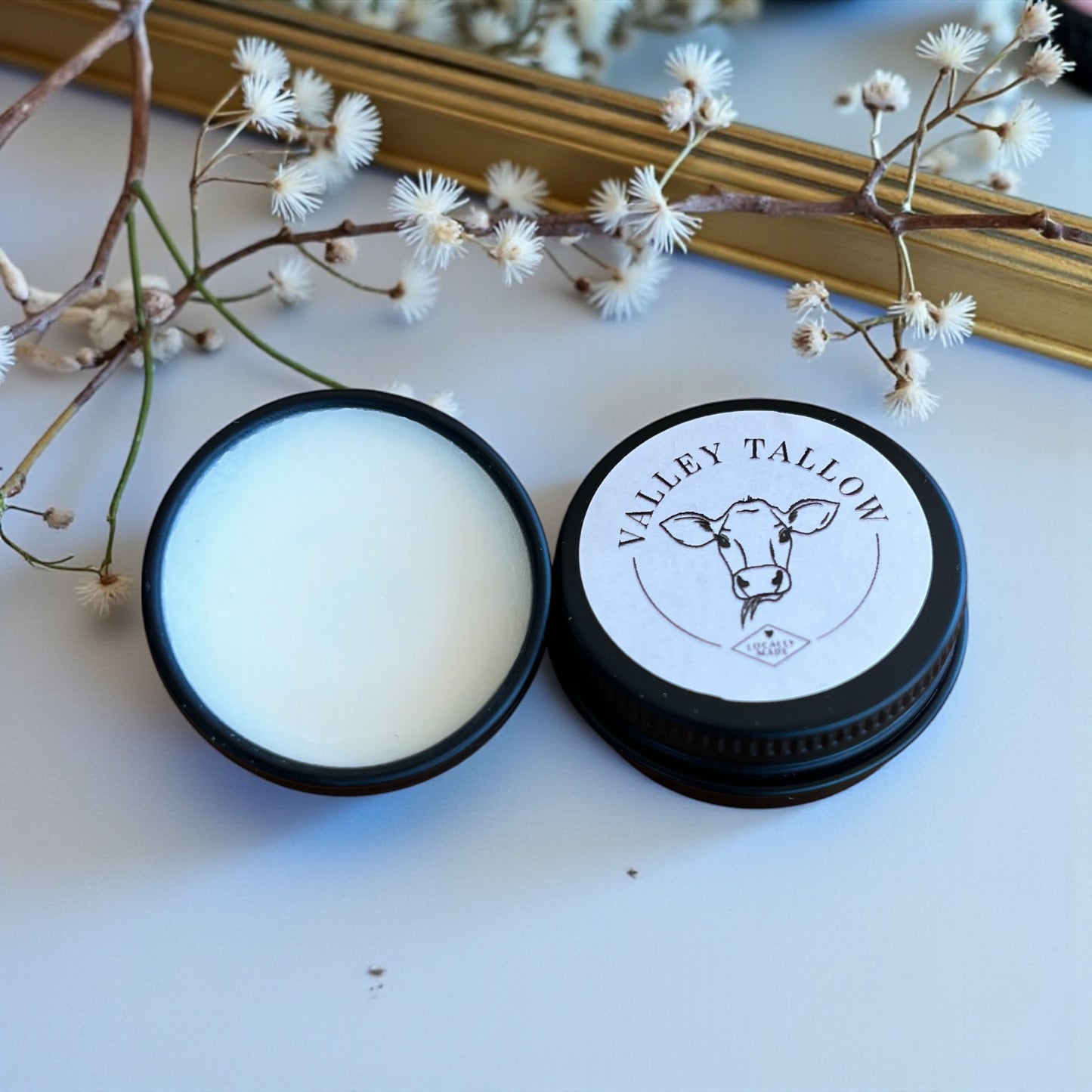 Open tin of Tasmanian tallow lip balm with smooth nourishing texture