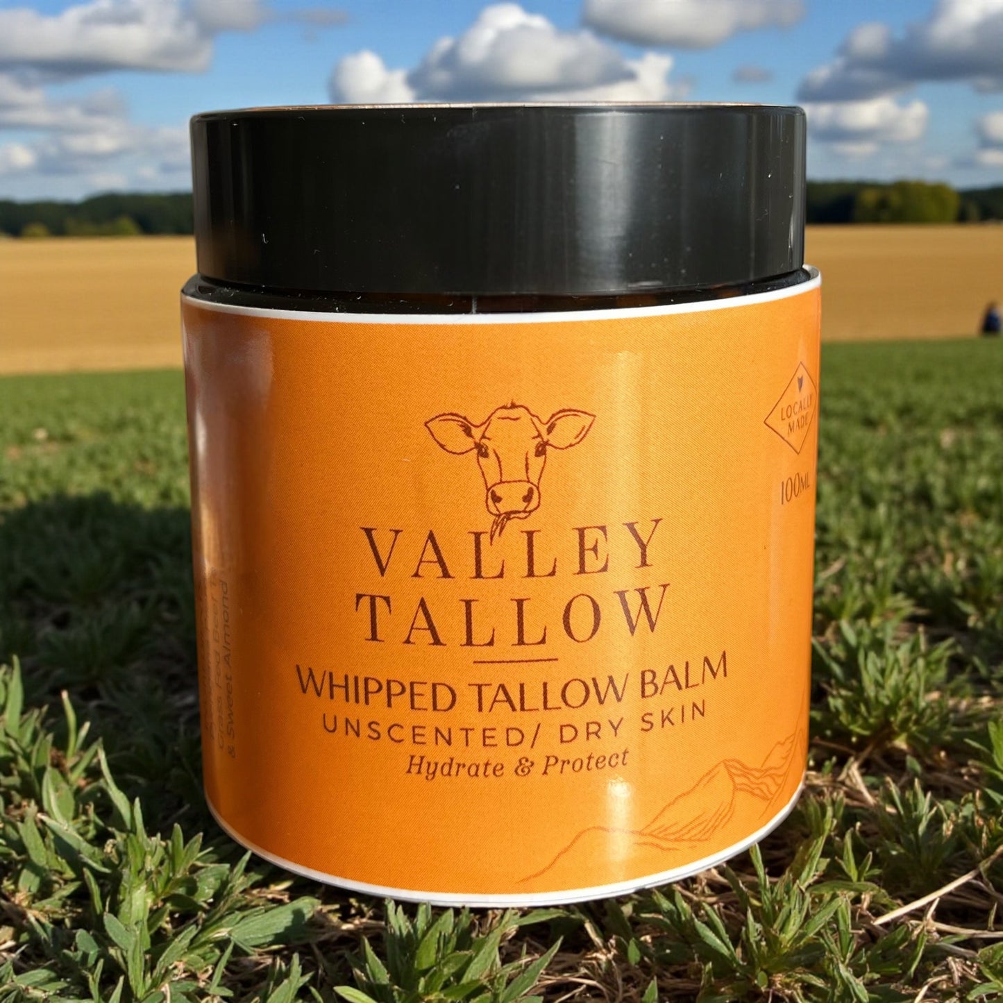 Valley Tallow whipped Tasmanian tallow balm jar on a grassy field background