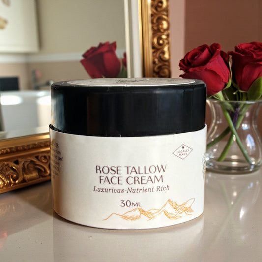 Tasmanian Valley Tallow Rose Face Cream jar surrounded by fresh roses